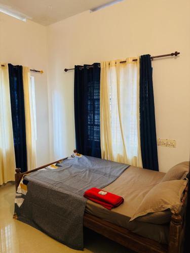 a bedroom with a bed with a red towel on it at MOON VILLA 01 varkala 3bhk with kitchen in Varkala