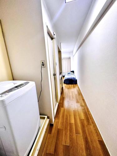 a hallway with a washer and dryer in a room at West Shinjuku Entire House with 2beds in Tokyo
