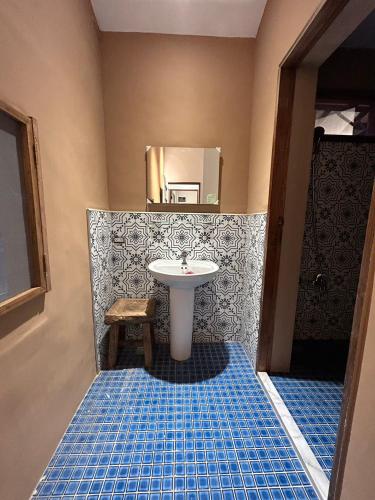 a bathroom with a white sink and a mirror at 池上包棟民宿-莊稼熟了三館 in Chishang