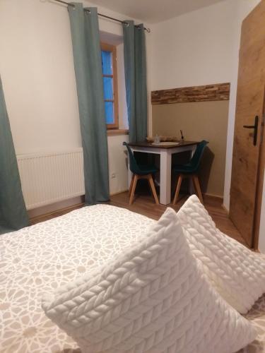 a bedroom with a bed and a table and a window at Völtl-Hof in Büchlberg