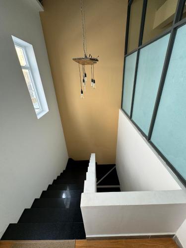 a staircase in a house with a stair case at Lá Homestay in Mỹ Phước