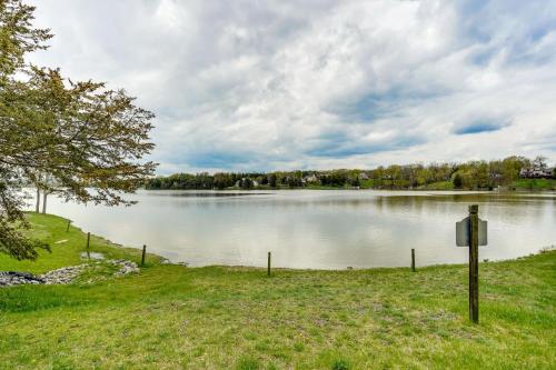 a large lake with a sign in the grass at Pet-Friendly Cabin Overlooking Sleepy Hollow Lake in Athens