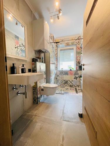 a bathroom with a sink and a toilet at Modernes LuxusApartment in Essen in Essen