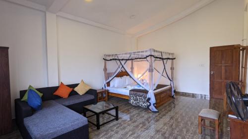 a living room with a couch and a bed at Lake view nest in Tangalle
