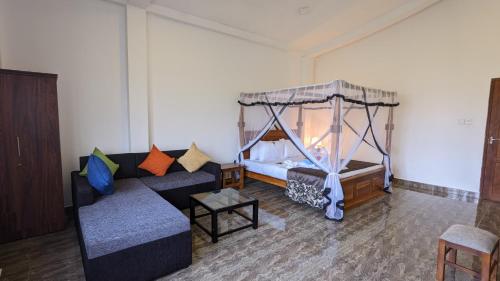 a living room with a bed and a couch at Lake view nest in Tangalle