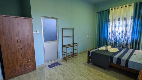 a bedroom with a bed and a ladder and a window at Lake view nest in Tangalle