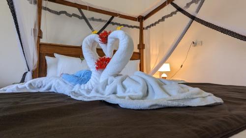 two swans are made to look like they are on a bed at Lake view nest in Tangalle