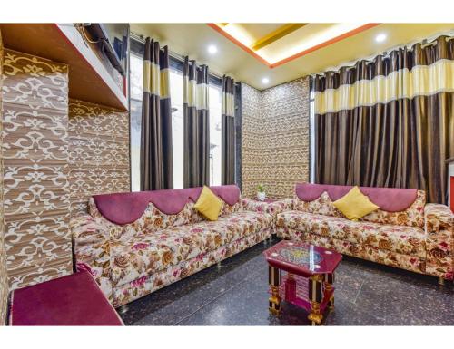 a living room with a couch and a table at M K Hotel Restaurant, Jammu in Jammu