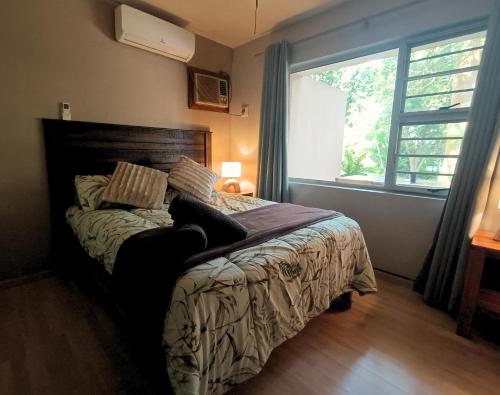 a bedroom with a bed with a large window at Just Property Zululand in Richards Bay