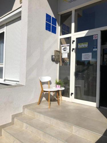 a chair sitting in front of a building at Mikulić Apartments in Zadar