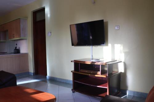 a living room with a flat screen tv on a wall at Azul Margarita Beach Resort in Bamburi