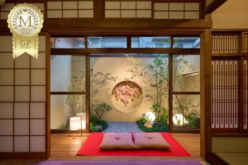 a room with a large window with a painting on the wall at KONJAKUSO Osaka Tengachaya "NIHONCHA" Tea & Relax in Osaka