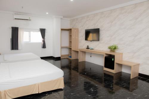 a hotel room with a bed and a tv at Miền Tây Hotel in Can Tho
