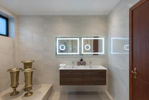 a bathroom with a sink and a mirror at Pax Manor Muthaiga in Nairobi