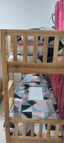 a wooden shelf with a pillow on it with ties at Magdalenas homestay in Anda