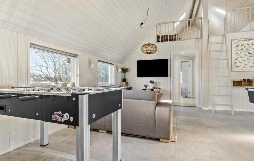 a kitchen with a stove top in a living room at Amazing Home In Rømø With Sauna in Toftum