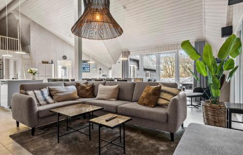 a living room with a couch and a table at Amazing Home In Rømø With Sauna in Toftum