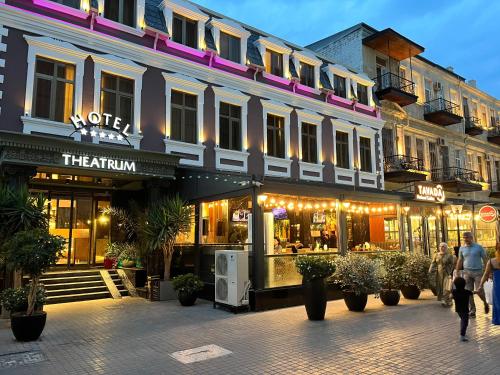 a building on a street with people walking in front of it at Theatrum Hotel Baku in Baku