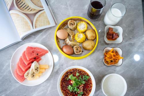 a table with plates of food and bowls of food at Z HOTEL- Qingchengshan in Dujiangyan