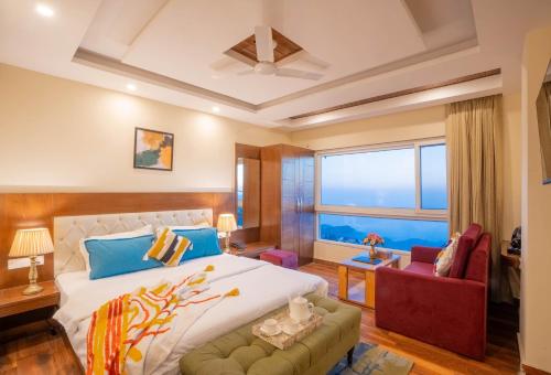 a bedroom with a large bed and a large window at Perfectstayz Value Valley Vista 5 min walk to Mall road in Mussoorie