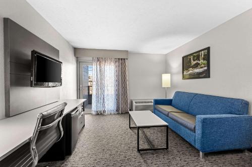 a living room with a blue couch in a hotel room at Quality Inn & Suites at Dollywood Lane in Pigeon Forge