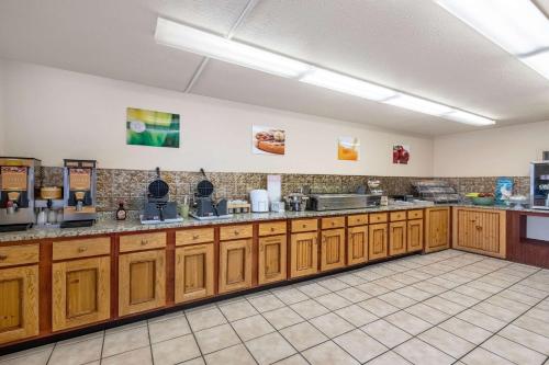 a large kitchen with wooden cabinets in a room at Quality Inn & Suites at Dollywood Lane in Pigeon Forge