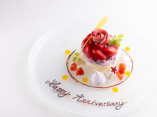 a dessert with a strawberry on a plate with a happy anniversary message at DoubleTree by Hilton Osaka Castle in Osaka