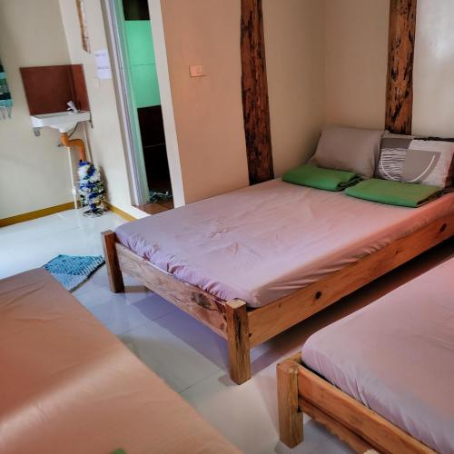 a bedroom with two beds in a room at Boone Homestay in Sagada