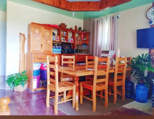 a dining room with a wooden table and chairs at Boone Homestay in Sagada