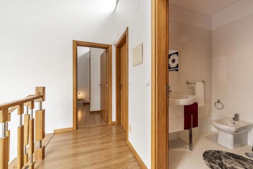a bathroom with a toilet and a sink at Serra e Mar Refuge in Sesimbra - Family Friendly home near the Arrábida Beachs in Sesimbra