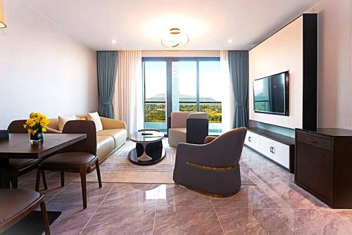 a living room with a couch and a table at Castle Bayview Resort & Spa in Kampot