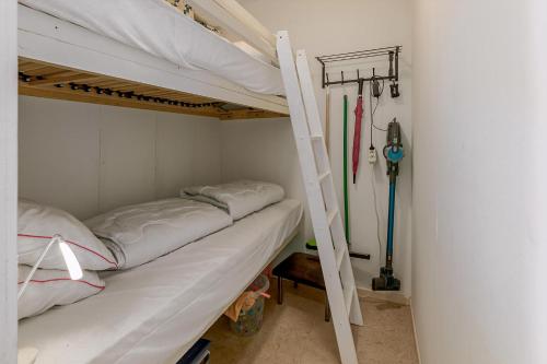 a bedroom with two bunk beds and umbrellas at Tivoli, 0103 in Oostduinkerke