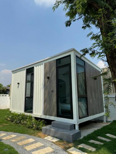 a small house with glass doors at Coolplay house in Bangkok