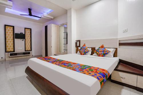 a bedroom with a large bed in a room at Hotel Sitara Inn in Trimbak