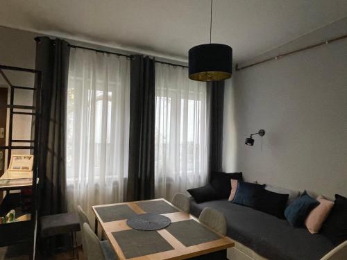 a living room with a couch and a table at “ApartCalm - like at Home” – close to Subway in Warsaw