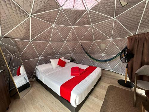 a bedroom with a bed in a room with a wall at Glamz Hills in Cameron Highlands
