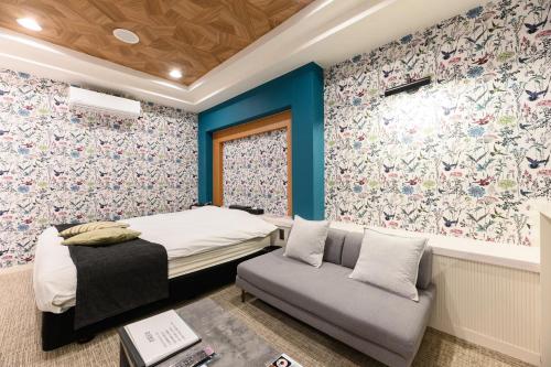 a small bedroom with a bed and a couch at HOTEL FARINA DOLCE (Adult Only) in Kanuma