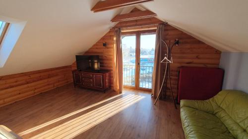a living room with a couch and a television at Prie Galvės in Trakai