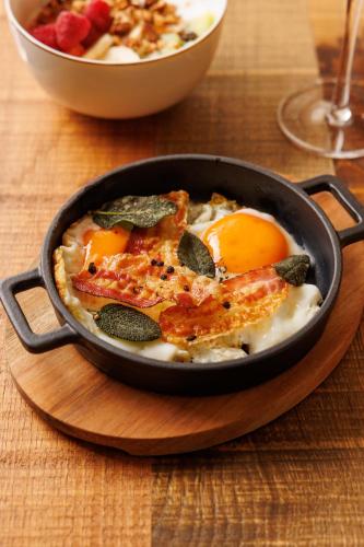a frying pan with eggs on a wooden table at Antichi Casali di Charme in Orvieto