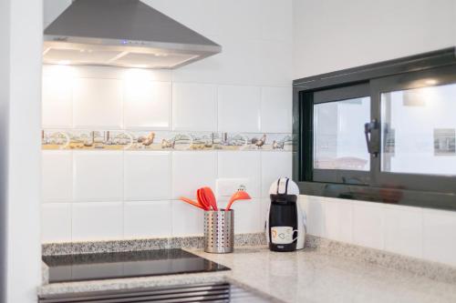 a kitchen with a counter top with utensils at Apartamento Cala´n Bosch Planta Bj in Cala'n Bosch