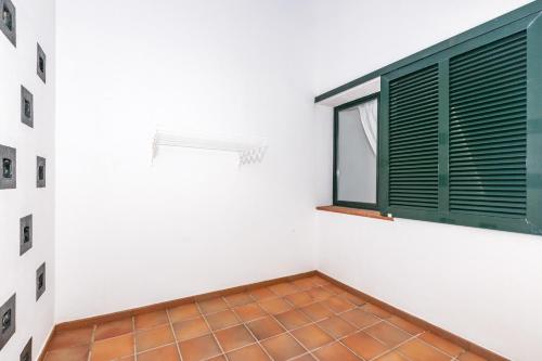 a room with a window and a tile floor at Apartamento Cala´n Bosch Planta Bj in Cala'n Bosch