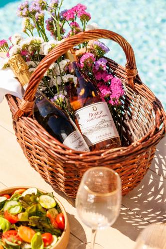 a basket of wine and a salad and a glass of wine at Antichi Casali di Charme in Orvieto