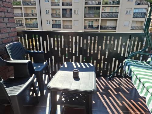 a patio with two chairs and a table with a vase on it at Comfort Apartment, New City Center - Free Parking in Ferizaj