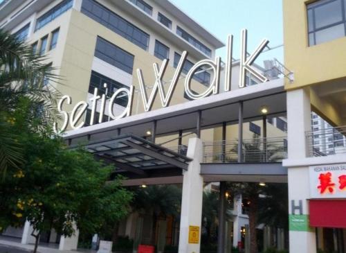 a building with a large sign on top of it at Signature Hotel by Easy Nap in Puchong