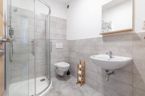 a bathroom with a sink and a toilet and a shower at Sport HOTEL Bečva in Valašské Meziříčí