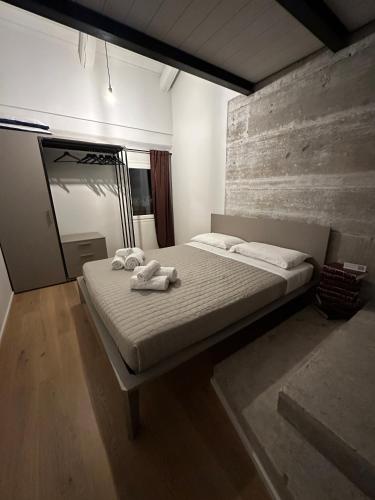 a bedroom with a bed with two towels on it at Loft 56 in Porto SantʼElpidio