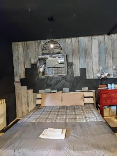 a bedroom with a bed and a mirror at Red Clay Apartments City Club in Belgrade