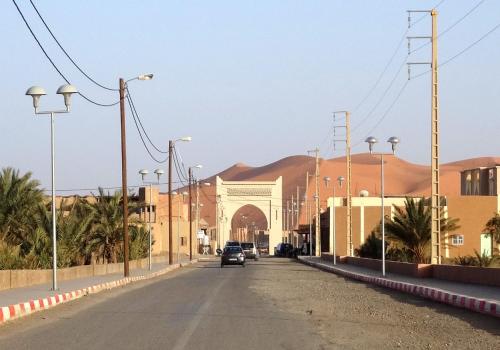 a street in front of a building with a gate at Authentic Sahara Desert Camps in Merzouga