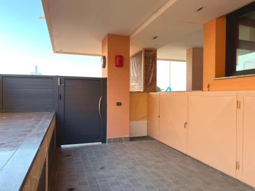 a large kitchen with two garage doors and tile floors at Capitol Apartments in Grado