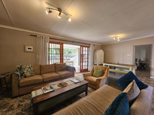 a living room with a couch and a table at GUINEA FOWL in Plettenberg Bay